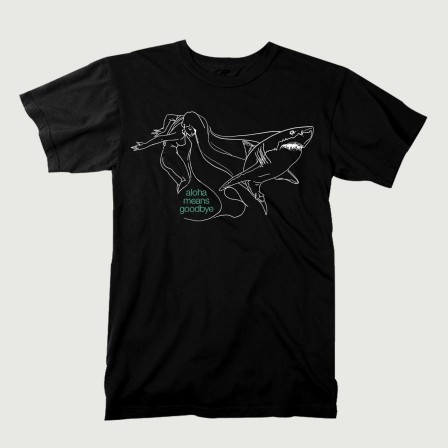 A black T-shirt with the title Aloha Means Goodbye in green, and a white line drawing of a woman with very long hair, and a shark.